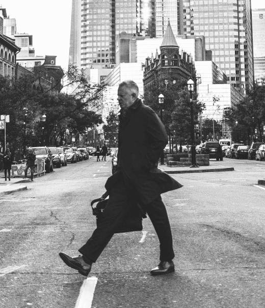 Man walking in city with briefcase.